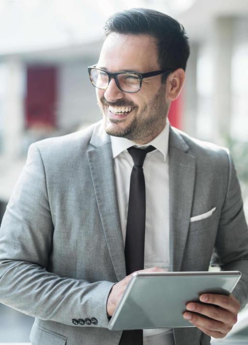 Man smiling holding tablet